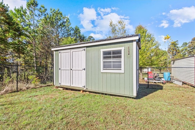 view of outdoor structure featuring a lawn