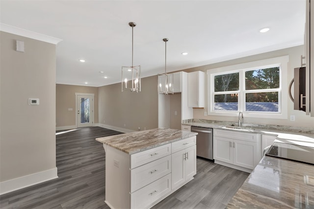 kitchen with white cabinets, a center island, stainless steel appliances, and a wealth of natural light