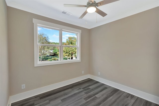 empty room featuring ceiling fan, dark hardwood / wood-style flooring, and ornamental molding