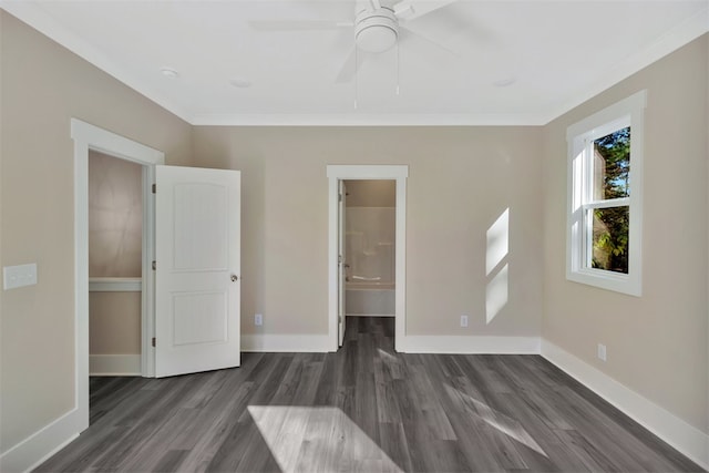 unfurnished bedroom featuring dark hardwood / wood-style floors, ensuite bath, ceiling fan, and ornamental molding