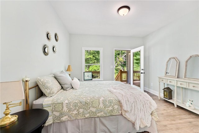 bedroom with access to outside and light hardwood / wood-style flooring