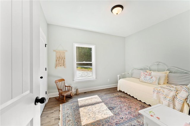 bedroom with hardwood / wood-style flooring