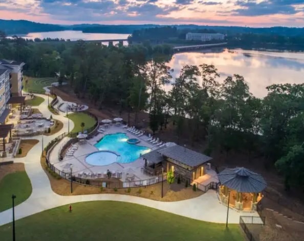 pool at dusk featuring a water view