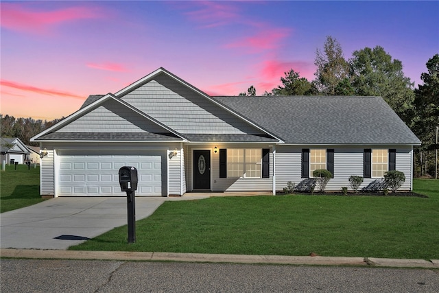 ranch-style house with a yard and a garage