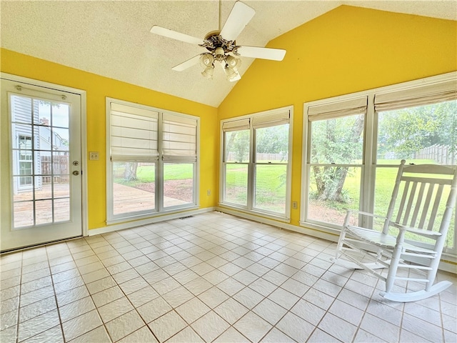 unfurnished sunroom featuring ceiling fan and vaulted ceiling