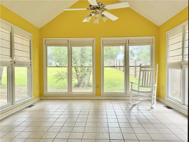 unfurnished sunroom with a wealth of natural light, ceiling fan, and lofted ceiling