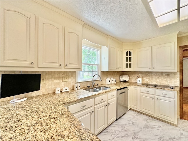 kitchen with tasteful backsplash, sink, stainless steel dishwasher, and a textured ceiling