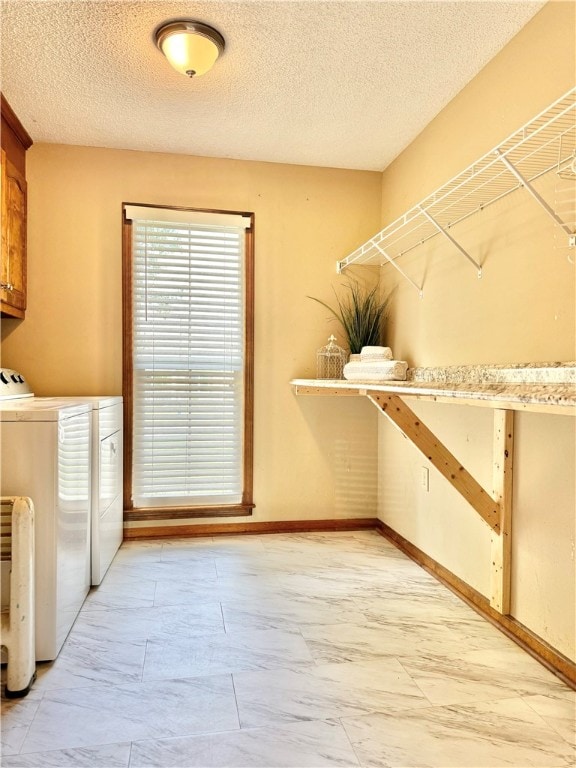 laundry room with a textured ceiling