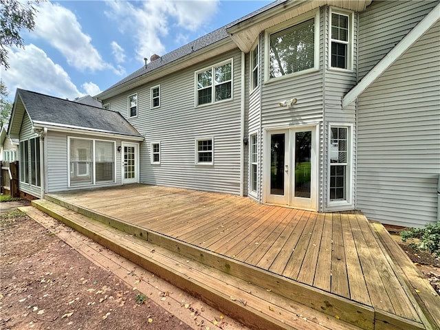 rear view of property featuring a wooden deck