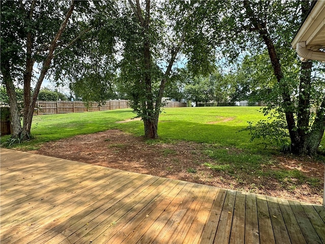 wooden terrace with a lawn