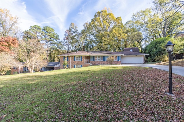 ranch-style home featuring a front lawn and a garage