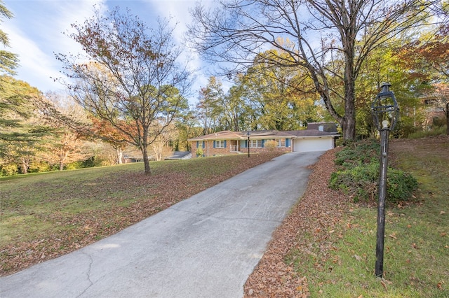 ranch-style house featuring a front lawn and a garage