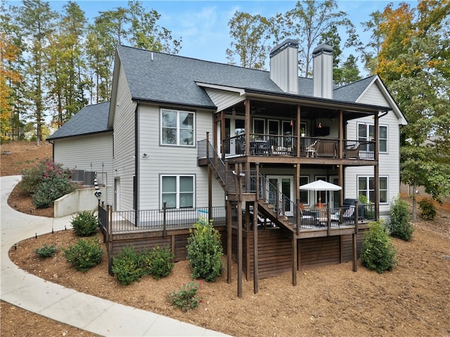 back of property with cooling unit and a wooden deck