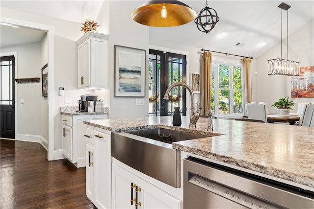 kitchen with pendant lighting, dishwasher, lofted ceiling, dark hardwood / wood-style floors, and white cabinetry