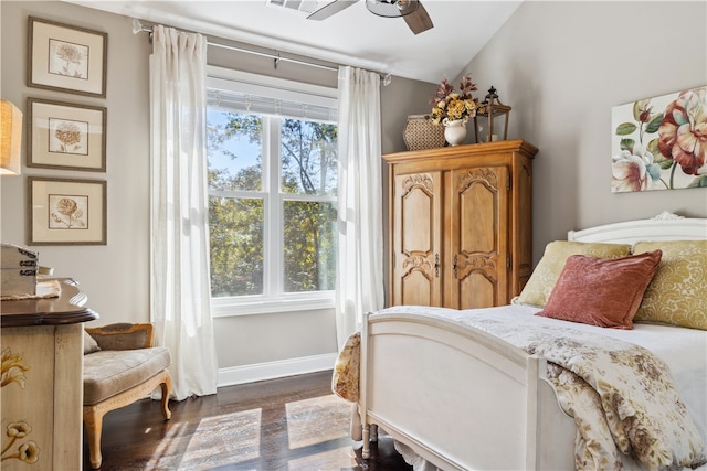 bedroom with dark wood-type flooring, ceiling fan, and lofted ceiling