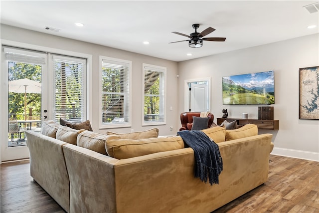 living room featuring hardwood / wood-style floors and ceiling fan