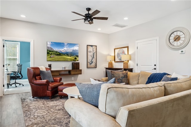 living room featuring hardwood / wood-style flooring and ceiling fan