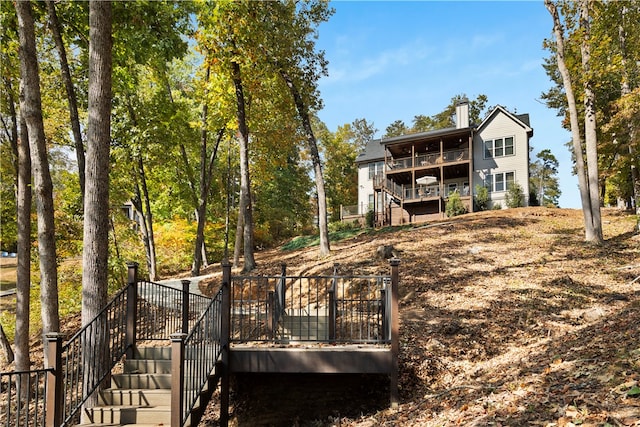 rear view of property featuring a deck