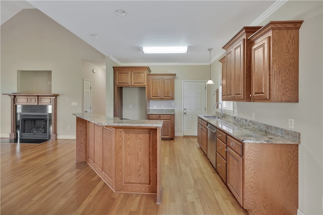 kitchen with dishwasher, sink, hanging light fixtures, light hardwood / wood-style flooring, and light stone counters