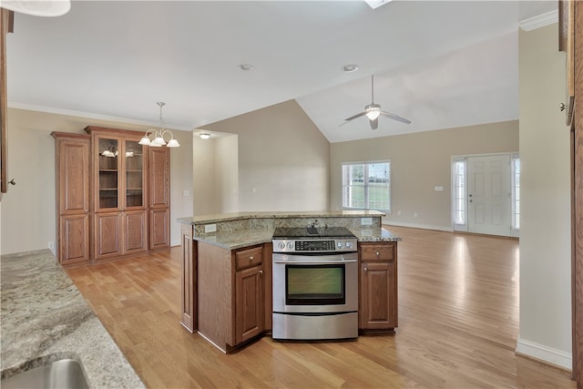 kitchen with light stone countertops, light hardwood / wood-style flooring, decorative light fixtures, vaulted ceiling, and stainless steel electric stove