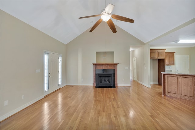 unfurnished living room featuring light wood-type flooring, high vaulted ceiling, and ceiling fan