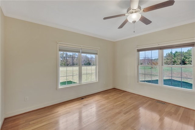 empty room with ceiling fan, light wood-type flooring, and crown molding