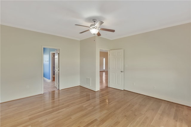 empty room with ceiling fan, light hardwood / wood-style floors, and ornamental molding