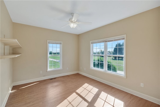 unfurnished room featuring ceiling fan and light wood-type flooring