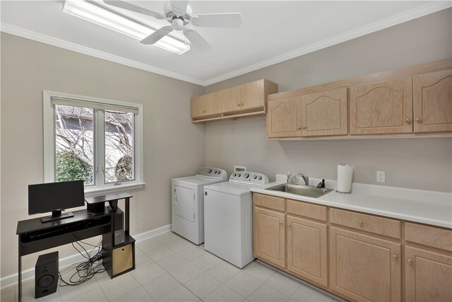 laundry room with washing machine and clothes dryer, ceiling fan, sink, cabinets, and crown molding