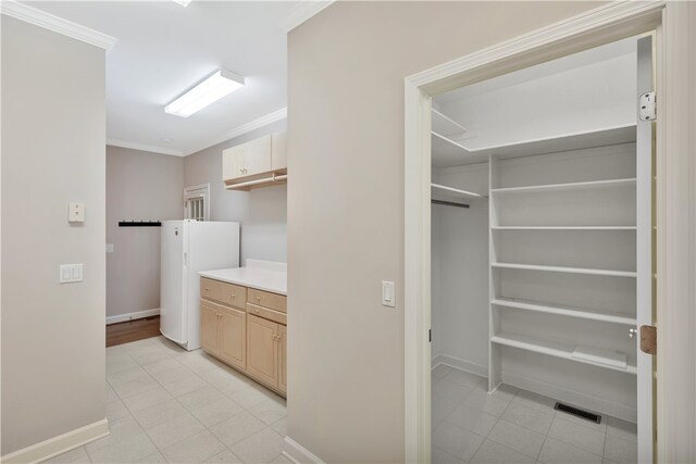 laundry area with ornamental molding