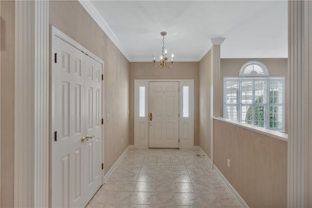 foyer featuring crown molding and a chandelier