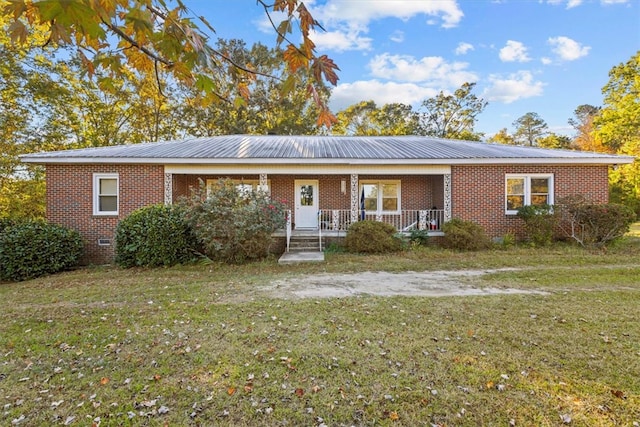 ranch-style home with covered porch and a front lawn