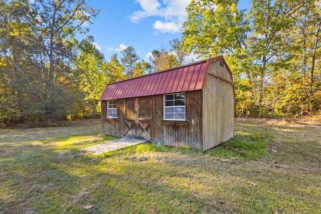 view of outdoor structure featuring a lawn