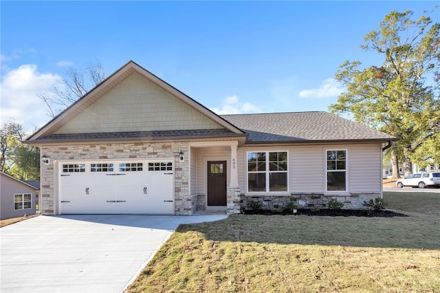 craftsman house with a garage and a front lawn