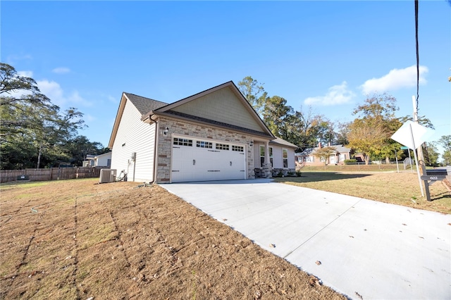 view of property exterior featuring a garage, central AC unit, and a lawn