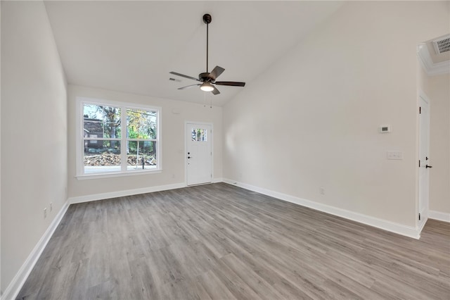 empty room with ceiling fan, high vaulted ceiling, and hardwood / wood-style flooring