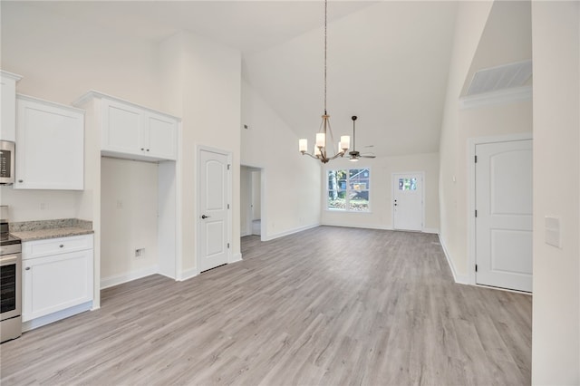 kitchen with white cabinets, high vaulted ceiling, and light hardwood / wood-style flooring