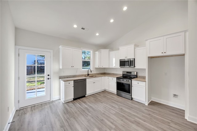 kitchen featuring white cabinets, stainless steel appliances, a healthy amount of sunlight, and sink