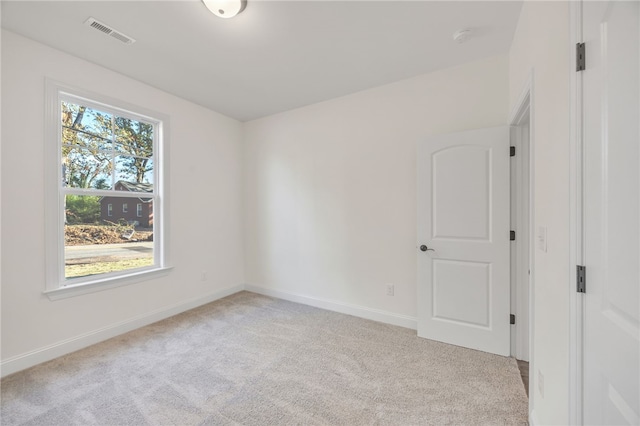 unfurnished room with light colored carpet