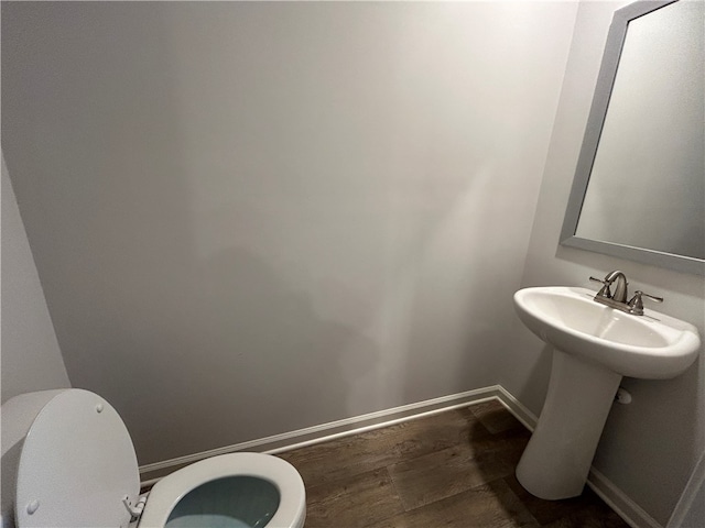 bathroom featuring toilet and hardwood / wood-style flooring