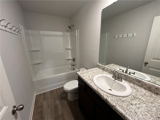 full bathroom featuring hardwood / wood-style floors, vanity, toilet, and shower / washtub combination