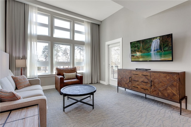 living room with plenty of natural light and light colored carpet