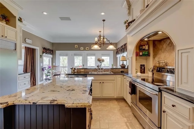 121 Turnberry Rd, Anderson, SC 29626 - kitchen with pendant lighting, an inviting chandelier, sink, cream cabinetry, and stainless steel appliances
