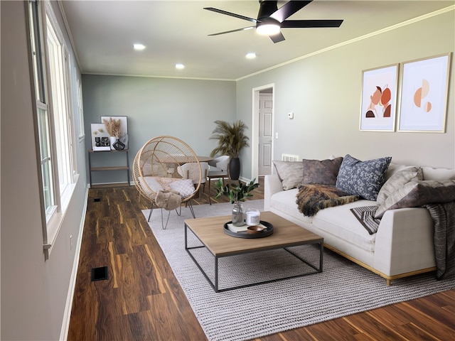 living room featuring dark hardwood / wood-style floors, ceiling fan, and crown molding