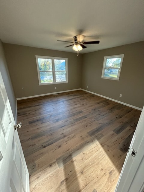 spare room featuring ceiling fan and dark hardwood / wood-style floors