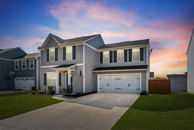 view of front of home featuring a yard and a garage