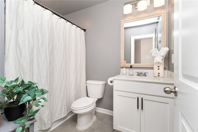 bathroom with tile patterned floors, vanity, and toilet