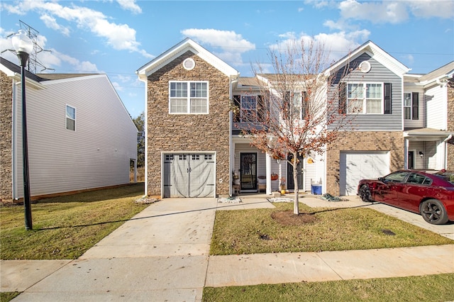 multi unit property featuring a garage and a front lawn