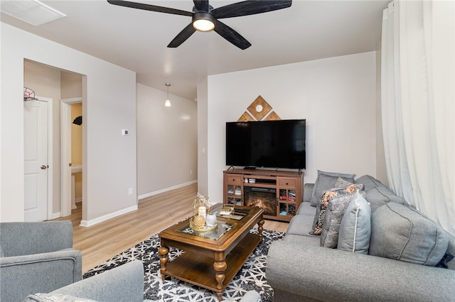 living room with ceiling fan and wood-type flooring