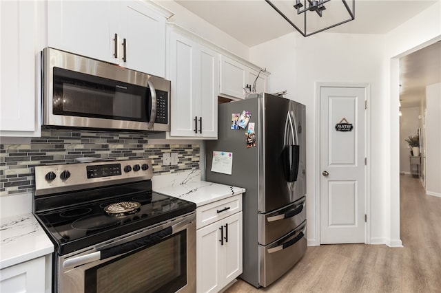 kitchen with light wood-type flooring, white cabinetry, and stainless steel appliances